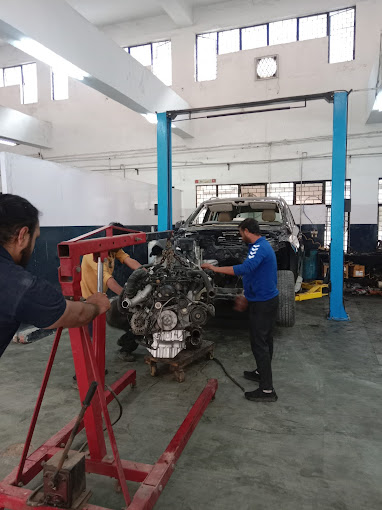 car repair worker performing repair work in engine