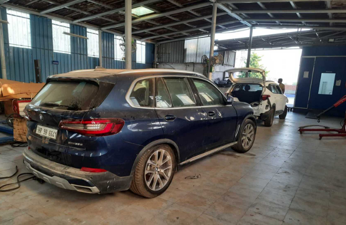 BMW cars undergoing inspection and repair inside workshop