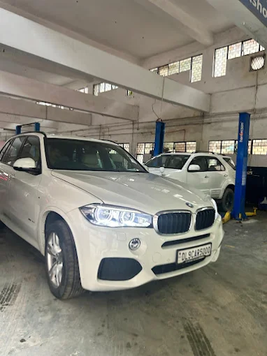 BMW car under inspection at XL Car Care workshop in Delhi NCR during repair service