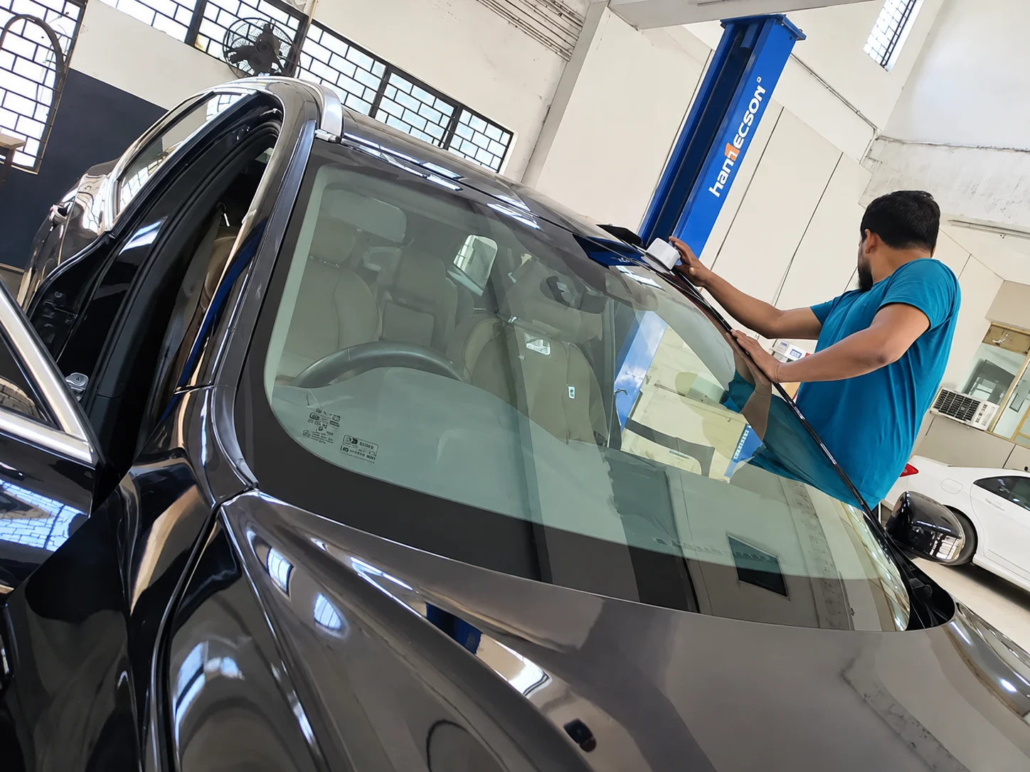 BMW windscreen repair and cleaning service in progress at car workshop in Delhi NCR